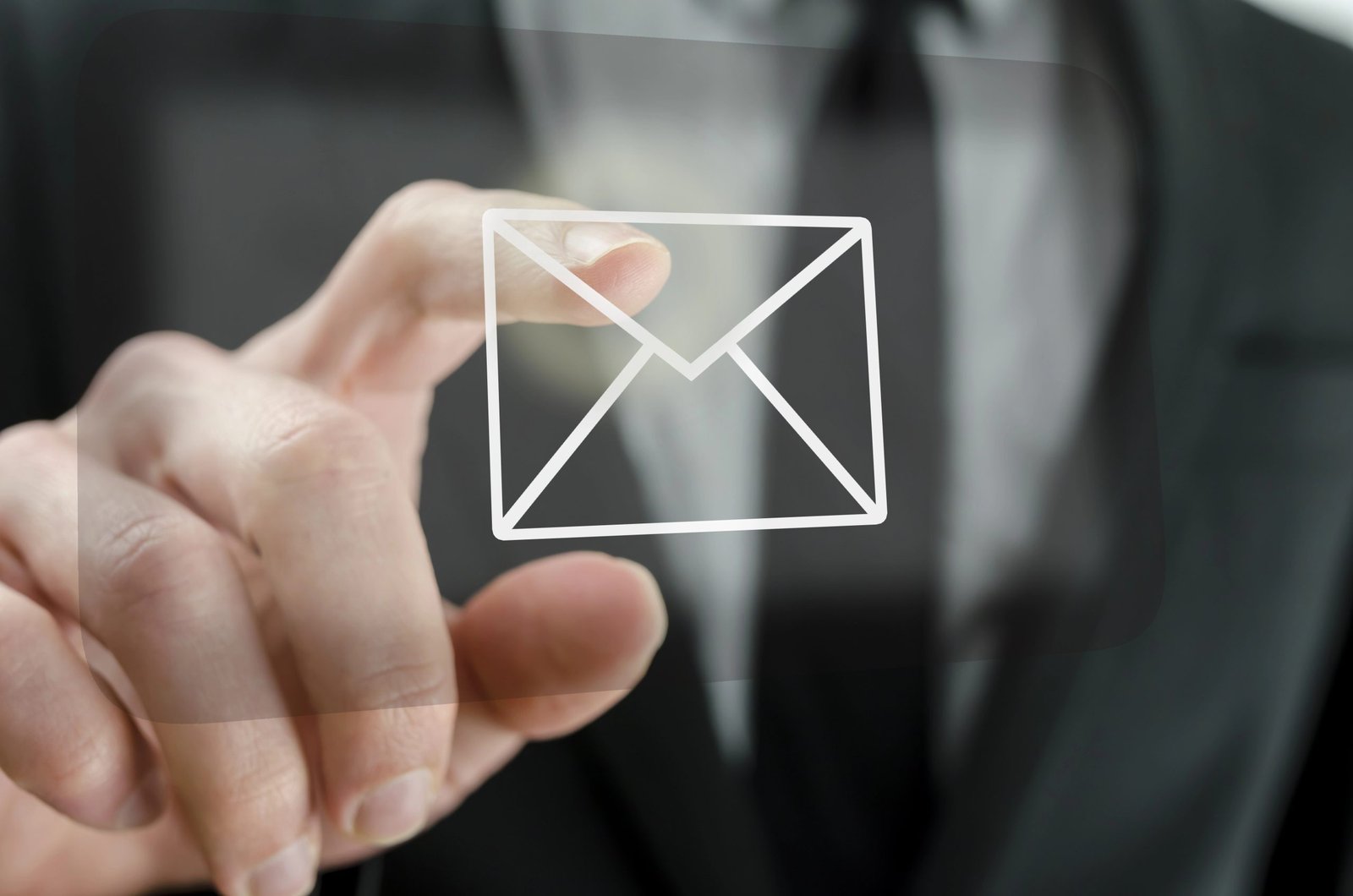Business professional interacting with digital email icon, symbolizing strategic email marketing for hospitality businesses.