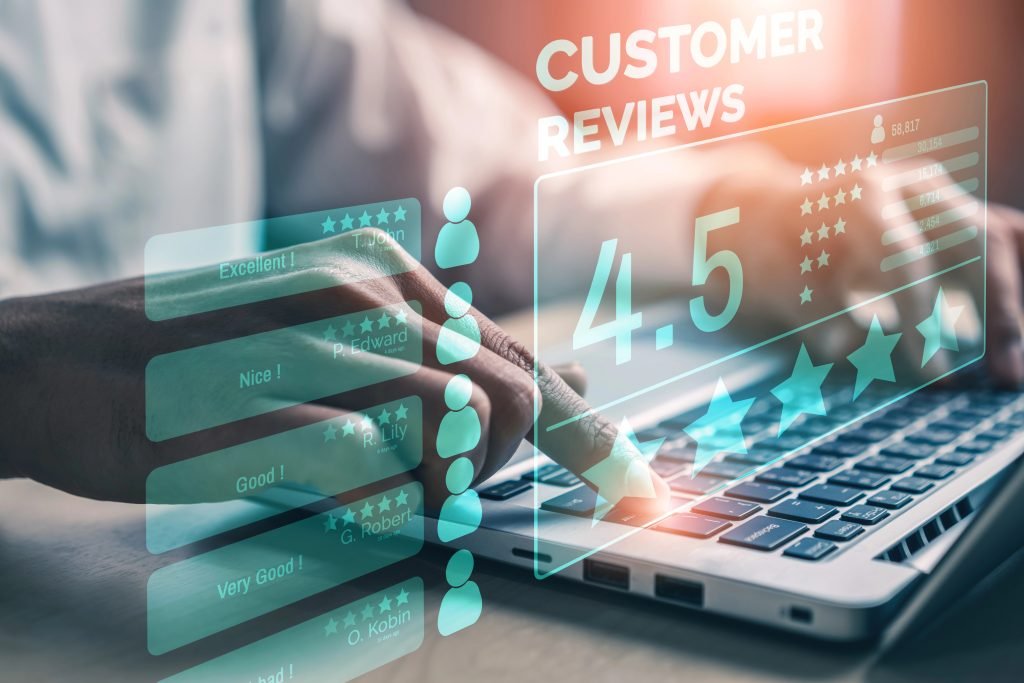 Hand typing on a laptop with digital customer reviews interface displaying a 4.5-star rating and feedback, emphasizing reputation management for local businesses.