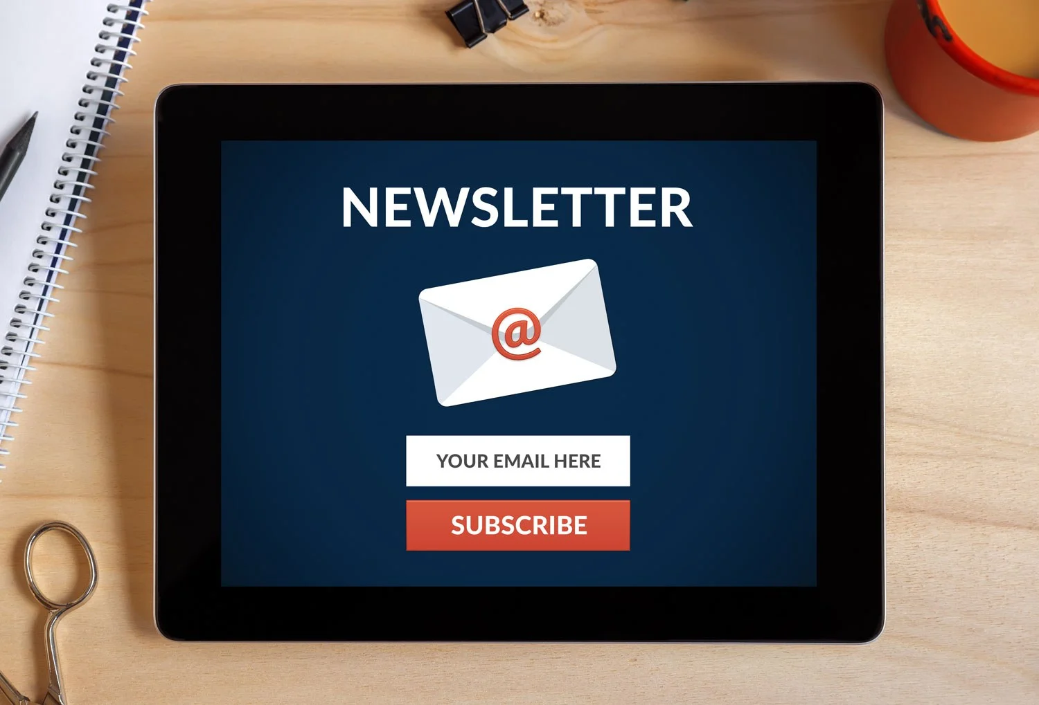 Tablet displaying a newsletter subscription form with a call to action, emphasizing email engagement for hospitality marketing.