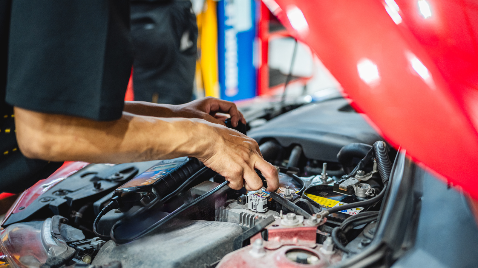 Auto repair technician working on vehicle engine components in workshop setting, emphasizing hands-on service and expertise for consistent shop growth.