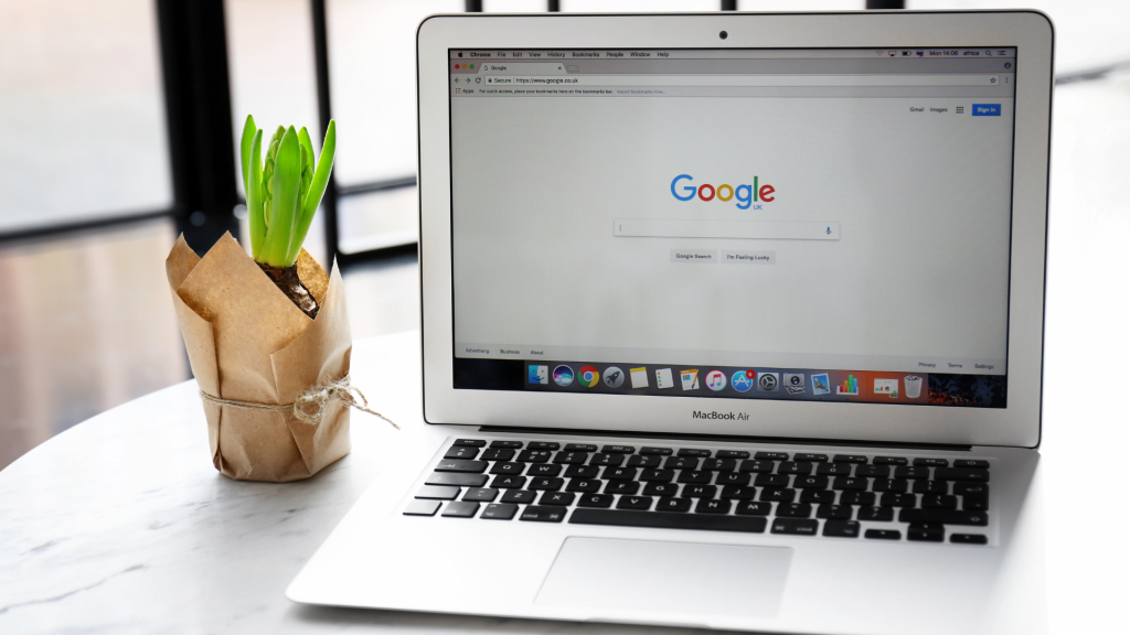 Laptop displaying Google search page alongside a potted plant, representing digital marketing and online lead generation strategies.