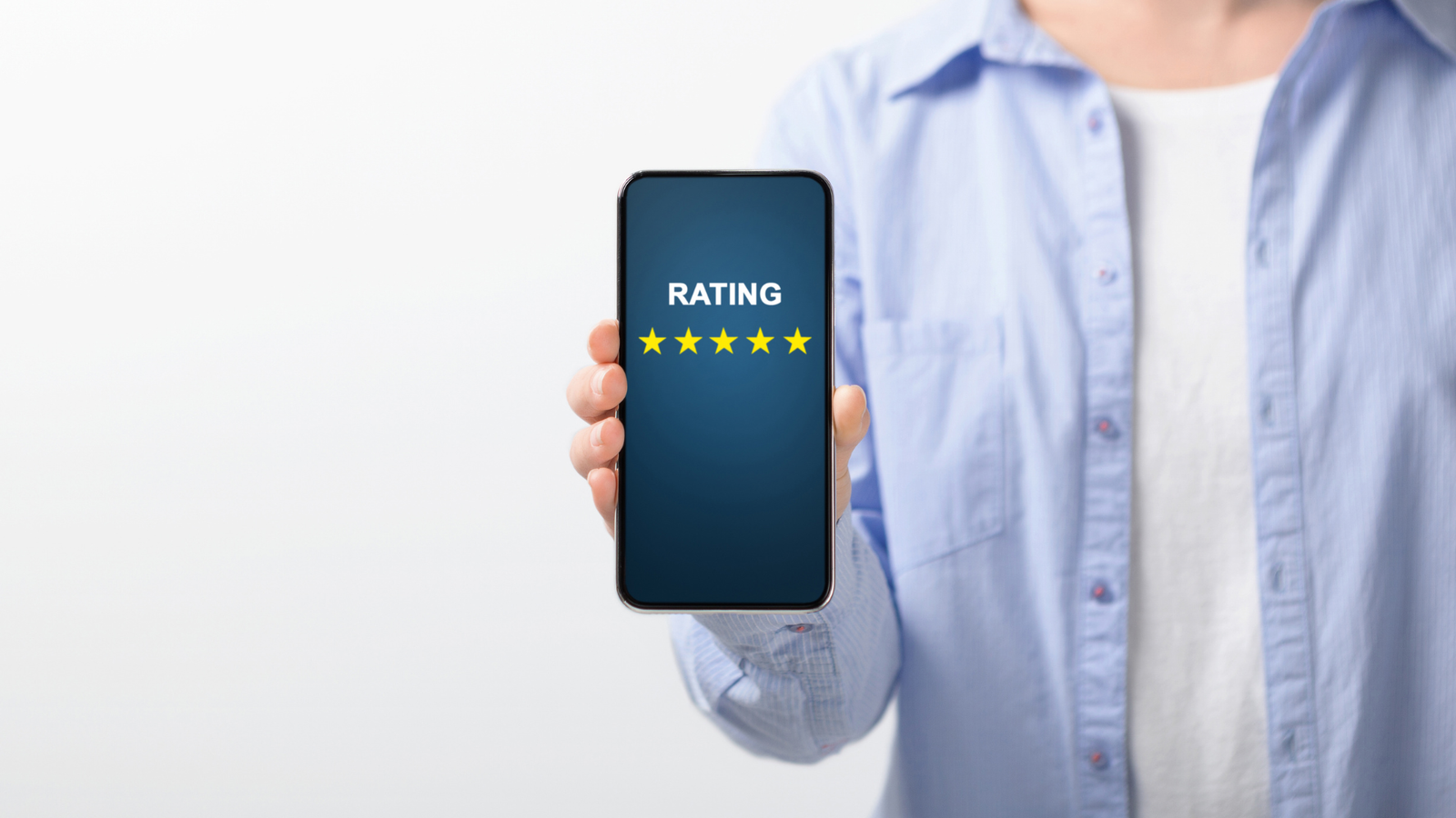 Person holding smartphone displaying a five-star rating, emphasizing online reputation management and review generation.